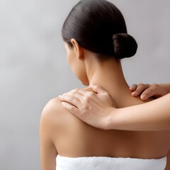 Professional Portrait of Back-Facing Woman with Elegant Updo in Minimalist Studio Setting