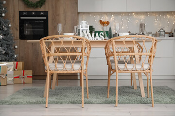 Dining table with Christmas setting in kitchen interior