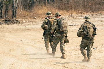 Fototapeta premium Backside of Soldier army operation, Military equipment, army helmet, warpaint, smoked dirty face