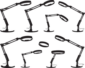 Black articulated desk lamps and magnifying glass rings