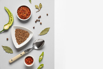 Composition with different spices and spoon on light background