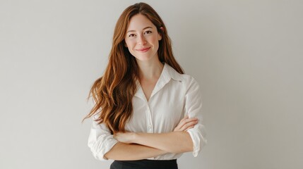 Professional headshot of woman with long hair wearing white shirt posing