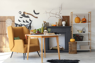Light living room with orange armchair and fireplace decorated for Halloween celebration