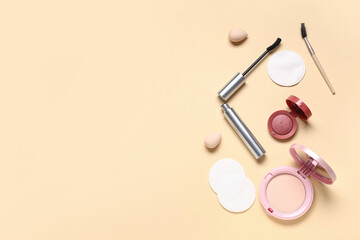 Composition with cotton pads, makeup sponge and cosmetic products on beige background