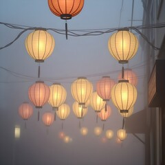 Obraz premium Paper lanterns glowing softly in a mist-covered street.
