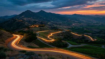 Fototapeta premium Serpentine Vineyard Road at Sunset: Dramatic Light Trails