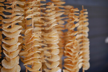 Crispy spiral potato snacks displayed at outdoor market