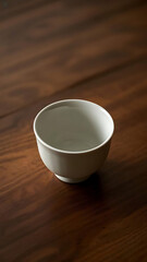 A simple empty white bowl on a dark wooden table, minimalist still life, 4k , product photography 