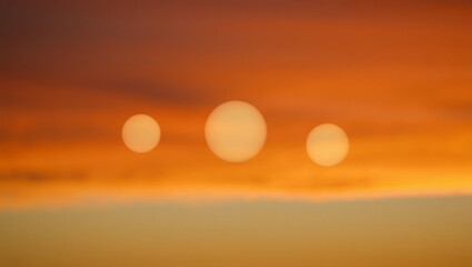 Abstract Sunset: Three Soft-Focus Suns in Warm Orange Sky, Peaceful and Serene Mood.