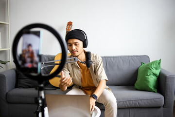 Smiling Male Musician Looking At The Camera Through Circular Ring Light Wearing Headphones
