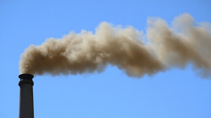 Smoke rising from a chimney against a clear blue sky.
