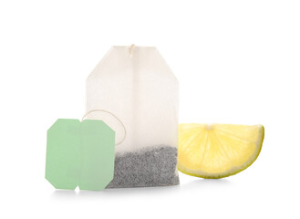 Piece of lemon with tea bag isolated on white background, closeup