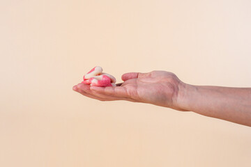 Fruit jelly mixed with sugar and hand on cream background