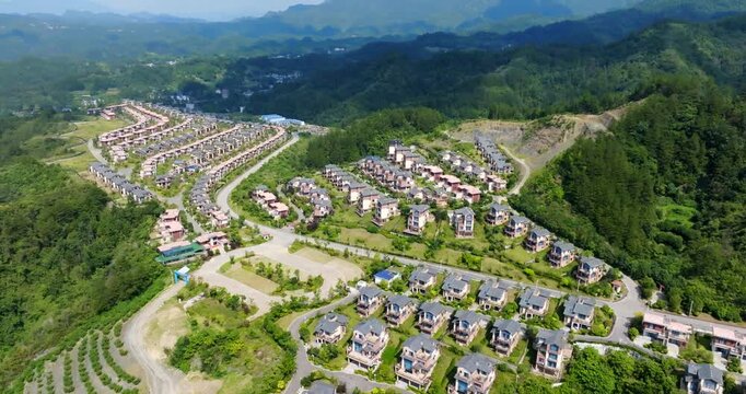 Panoramic drone shot tilting in front of vacation homes, sunny day in China