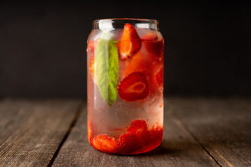 Refreshing summer cocktail with strawberries and rum on the rustic background. Selective focus.