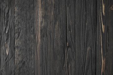 A detailed close-up of a natural rock surface featuring intricate brown, grey, and white mineral patterns and veins.