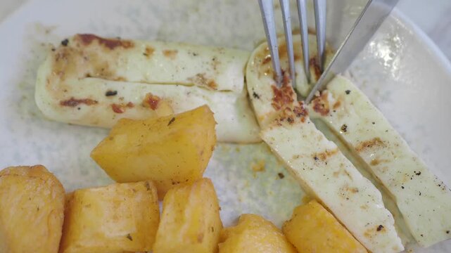 Enjoying grilled cheese with fried yuca in local eatery