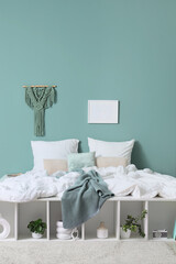 Interior of bedroom with big comfortable bed and shelving unit, closeup