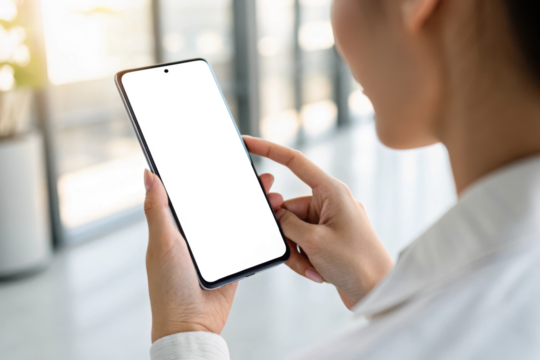 Woman holding a smartphone with a blank black screen