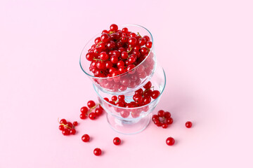 Dessert bowls with fresh red currants on pink background, closeup