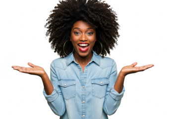 A happy african american woman with natural afro hair smiles with her mouth open and arms outstretched in a denim shirt against a transparent background