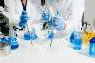 Fototapeta premium Scientists in a high tech lab conduct research with pipettes and tablets, blending medical innovation, data science, and futuristic digital healthcare technology.