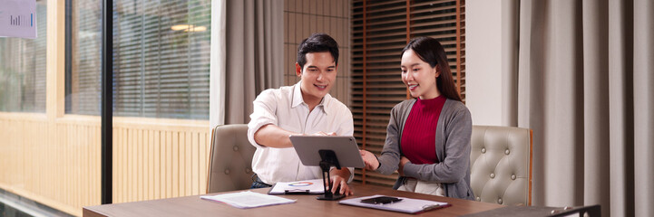 Asian adults collaborate business discussion tablet technology modern office environment strategic planning