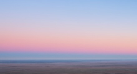Pastel Sky Over Tranquil Landscape: Serene Pink and Blue Sunset Hues