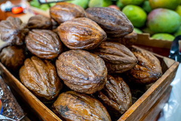 A Florida farmers market stand selling raw cacao beans with natural surface mold