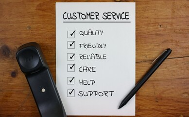 Checklist for Excellent Customer Service with Phone and Pen on Desk