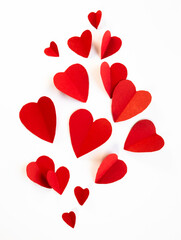 Red paper hearts in various sizes falling against a transparent background for Valentine's Day or romantic-themed designs
