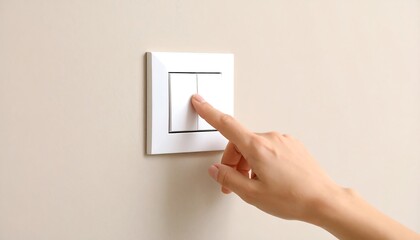 A hand presses a white double light switch mounted on a beige wall