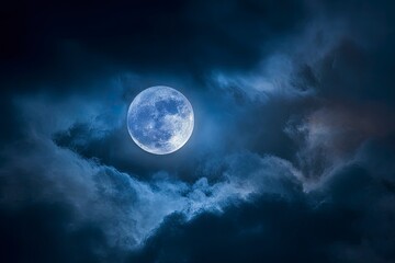 A full moon is visible in a dark night sky with dramatic clouds