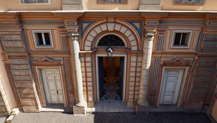 Ornate courtyard entrance with pastel-colored facade