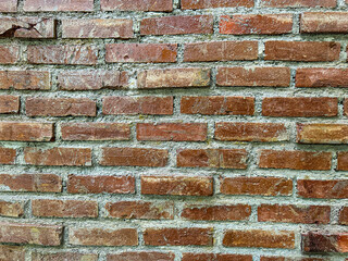 Old red brick wall with rough texture