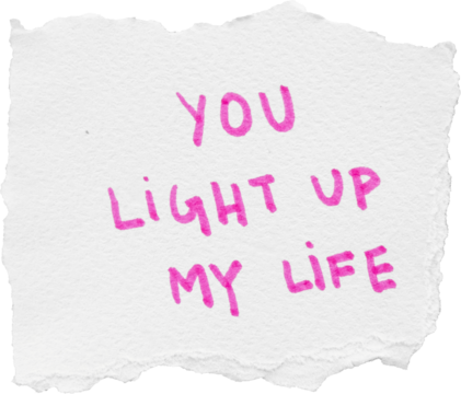 Handwritten pink text on white paper saying you light up my life with a torn edge for romantic or inspirational use