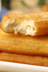 Crispy deep fried fritters served as a traditional breakfast delicacy at a bustling local eatery