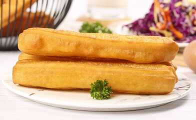 Crispy traditional fritters served on a plate with herbs showcasing culinary delight