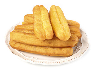 Crispy fritters stacked on a decorative plate showcasing their golden-brown texture against a clean background