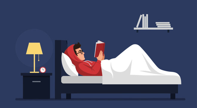 Boy Reading A Book In Bed Late At Night For Relaxation Before Sleep