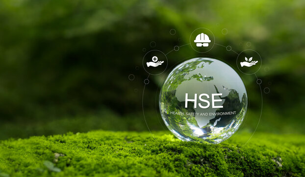Health, Safety and Environment HSE concept focusing on accident prevention, environmental protection, health and safety for business and organization. Crystal ball on moss in forest, green background.