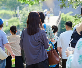 夏の観光名所白川郷のであい橋を渡る人々の観光客の姿