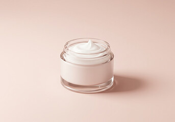 Small glass jar of white cream on a soft pink background