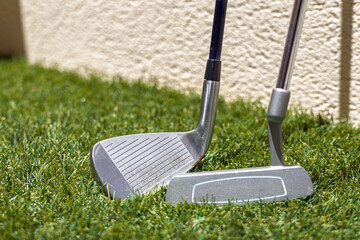 Golf Clubs Resting on Green Lawn