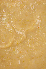 A detailed close-up, full-frame view of cooked mashed apples for apple pie, showcasing their smooth texture and subtle variations