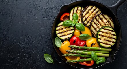 Delicious grilled vegetables including eggplant zucchini peppers and asparagus in a cast iron skillet