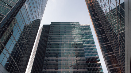 bottom view of the tall skyscrapers of the business district of a modern city
