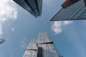 bottom view of the tall skyscrapers of the business district of a modern city