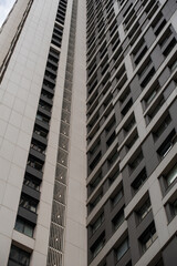 empty glass windows of a modern building with a reflection of the sky in the glass