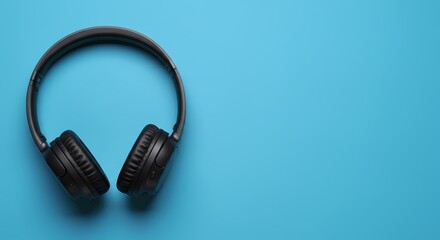 Overhead View of Black Headphones on a Blue Background
